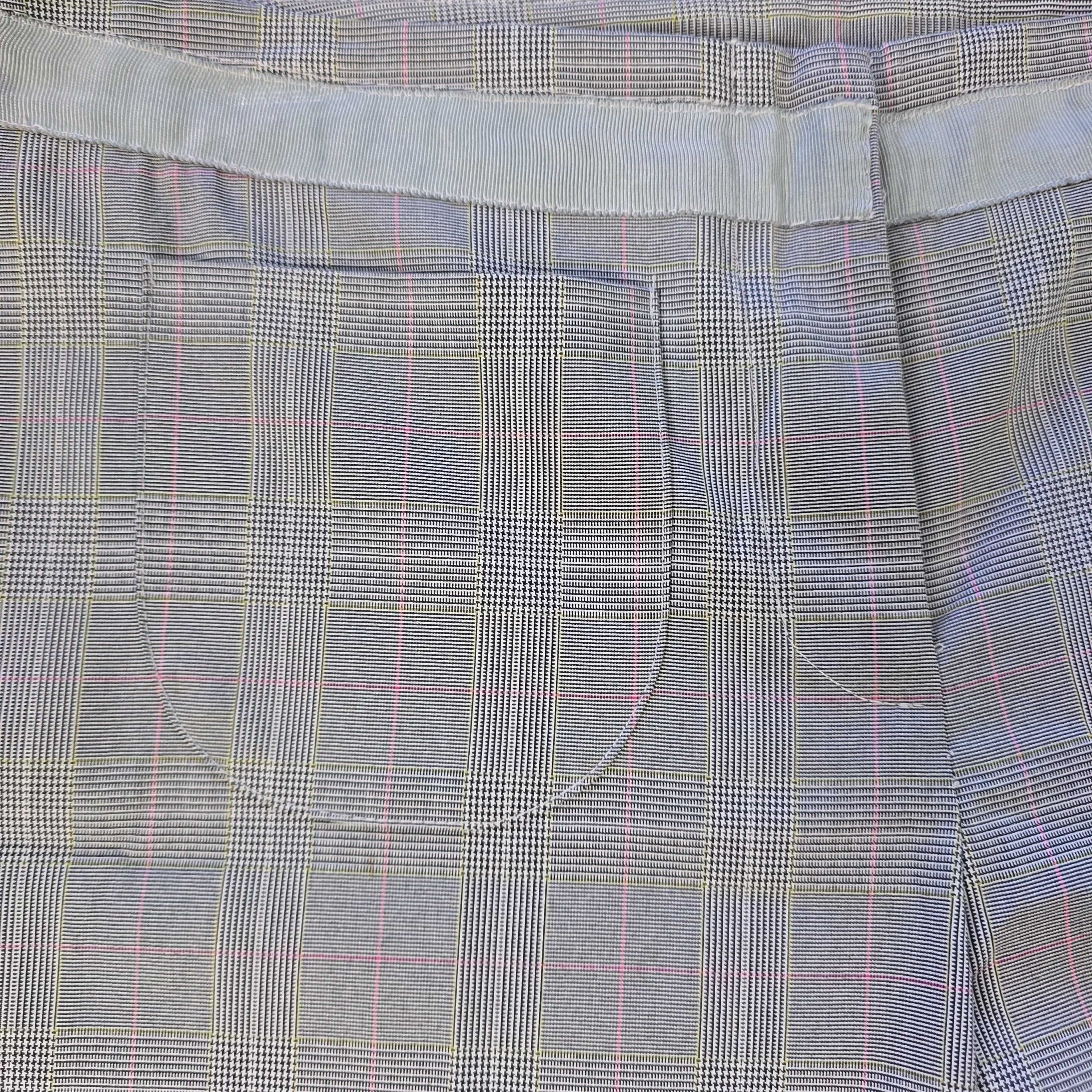 Close-up of a gray plaid fabric with a pocket detail