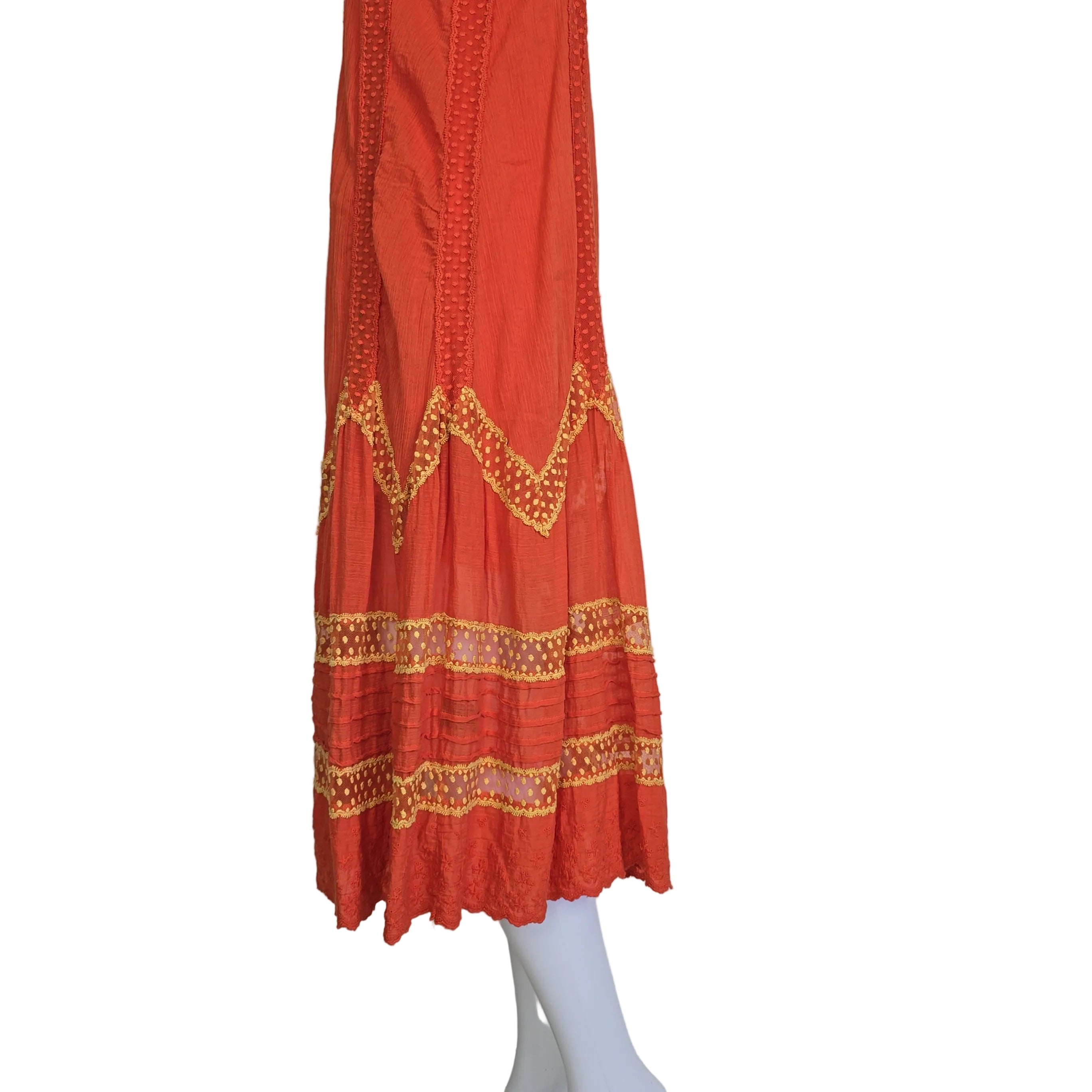 Orange dress with yellow embroidery on a light background