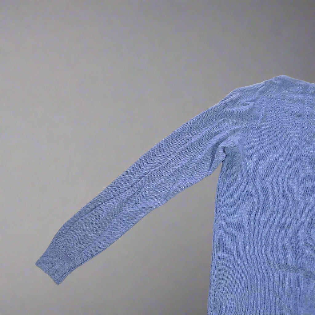 Blue long-sleeve shirt on a tiled floor