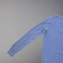 Blue long-sleeve shirt on a tiled floor