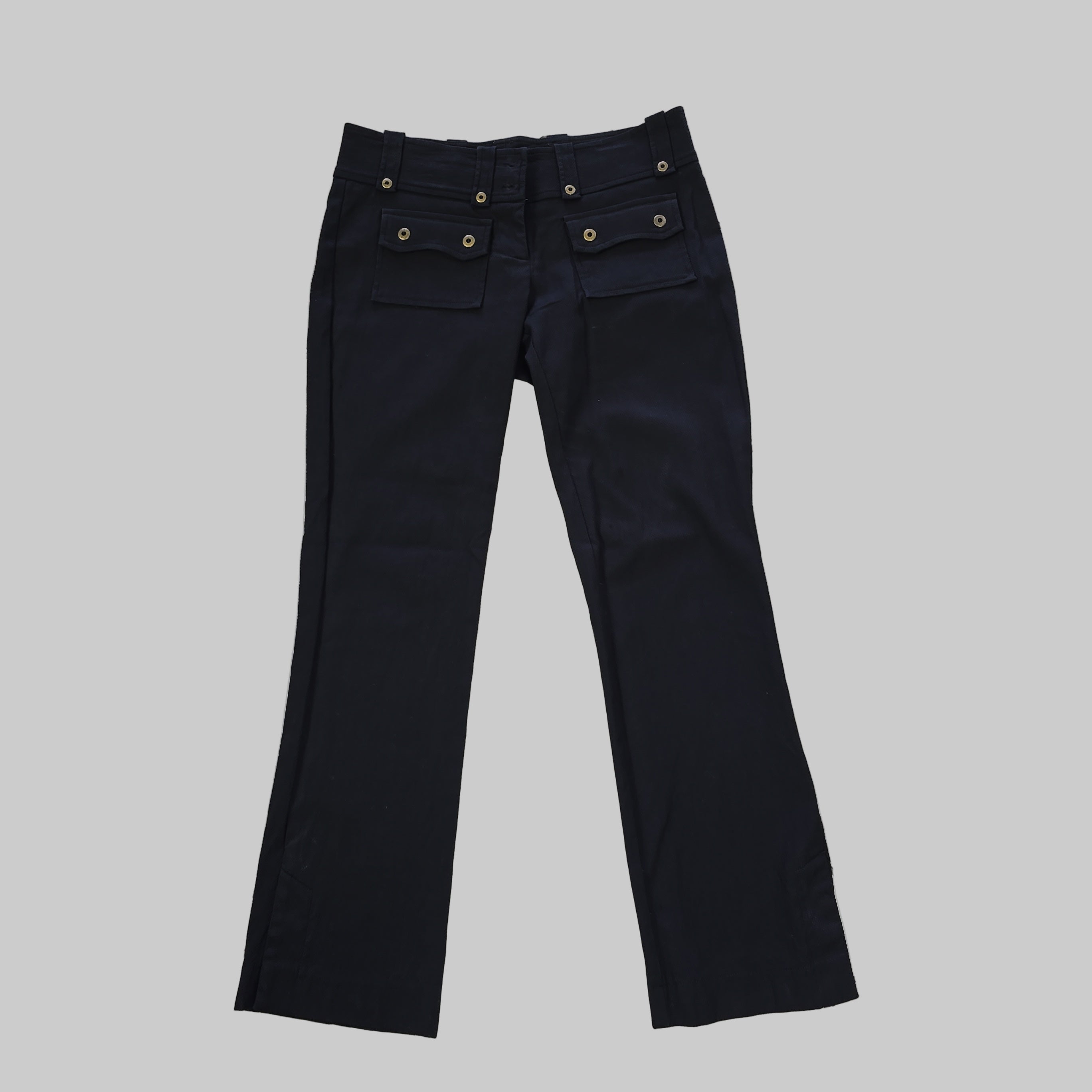 Black pants on a white tiled floor