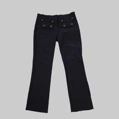 Black pants on a white tiled floor