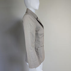 Gray jacket on a mannequin against a plain background