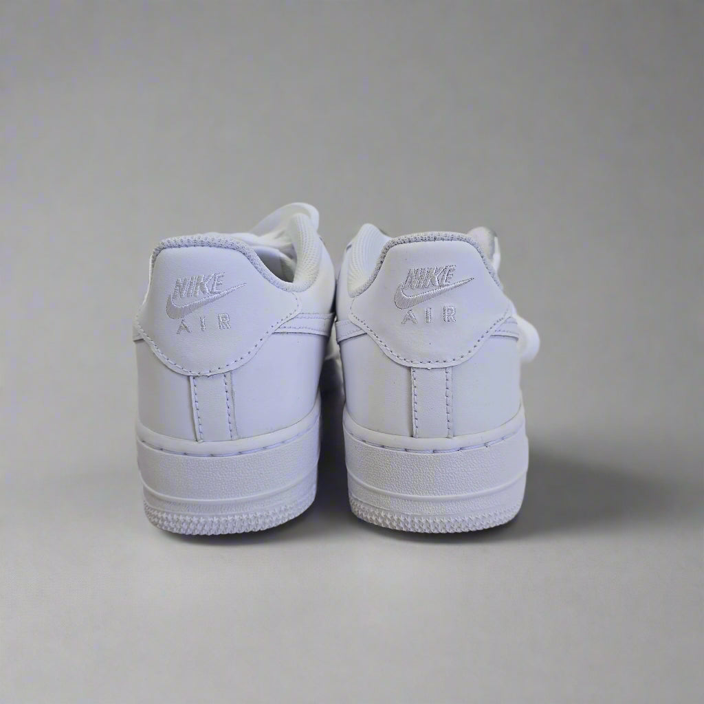 White Nike shoes on a light gray background