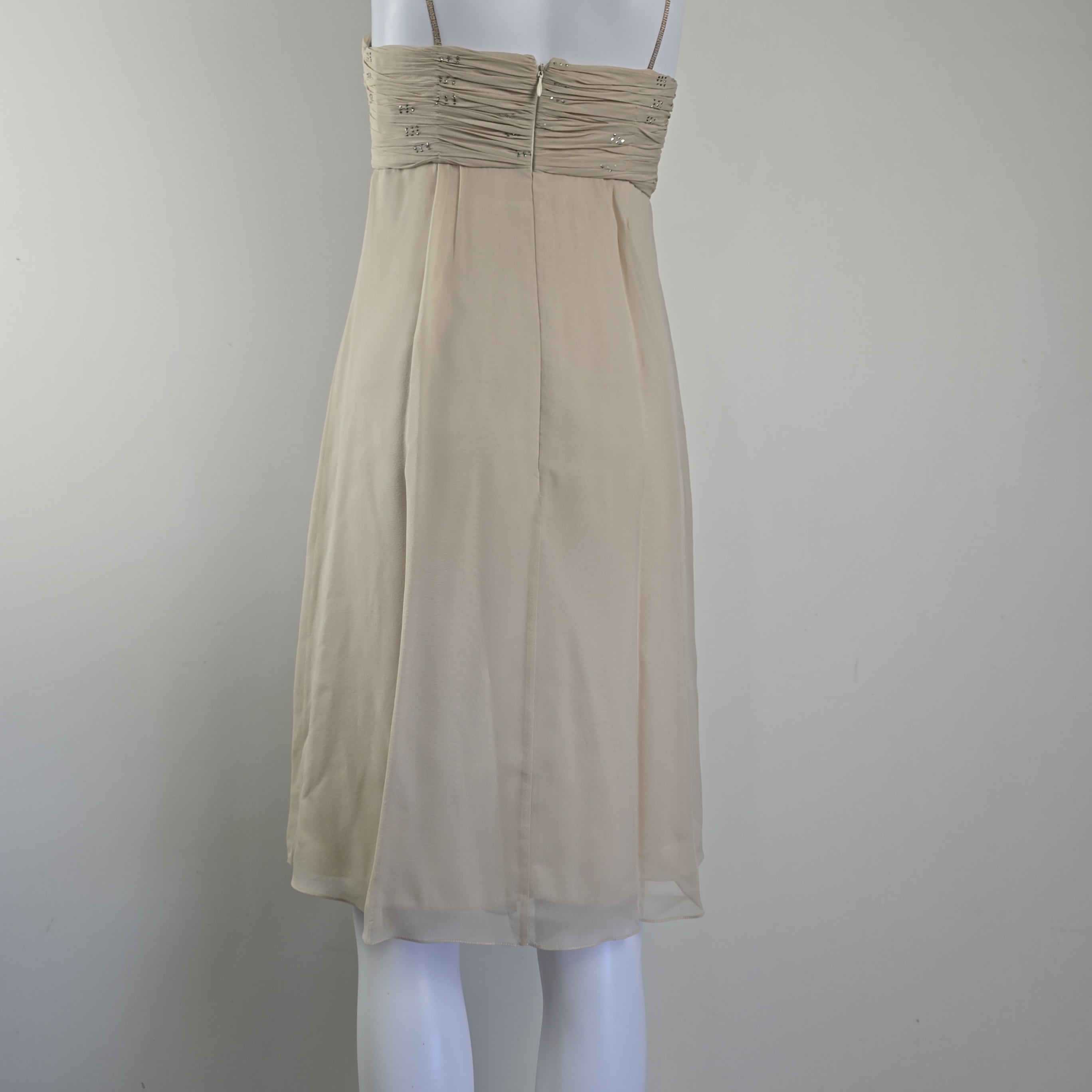 Beige dress on a mannequin against a white background