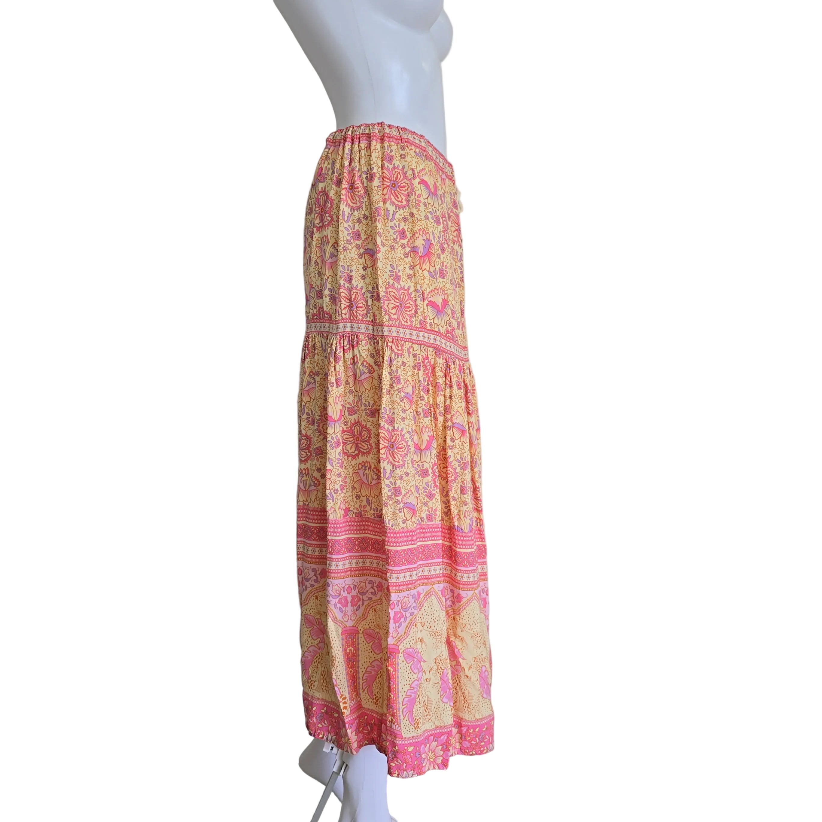 Colorful patterned skirt on a mannequin against a plain background