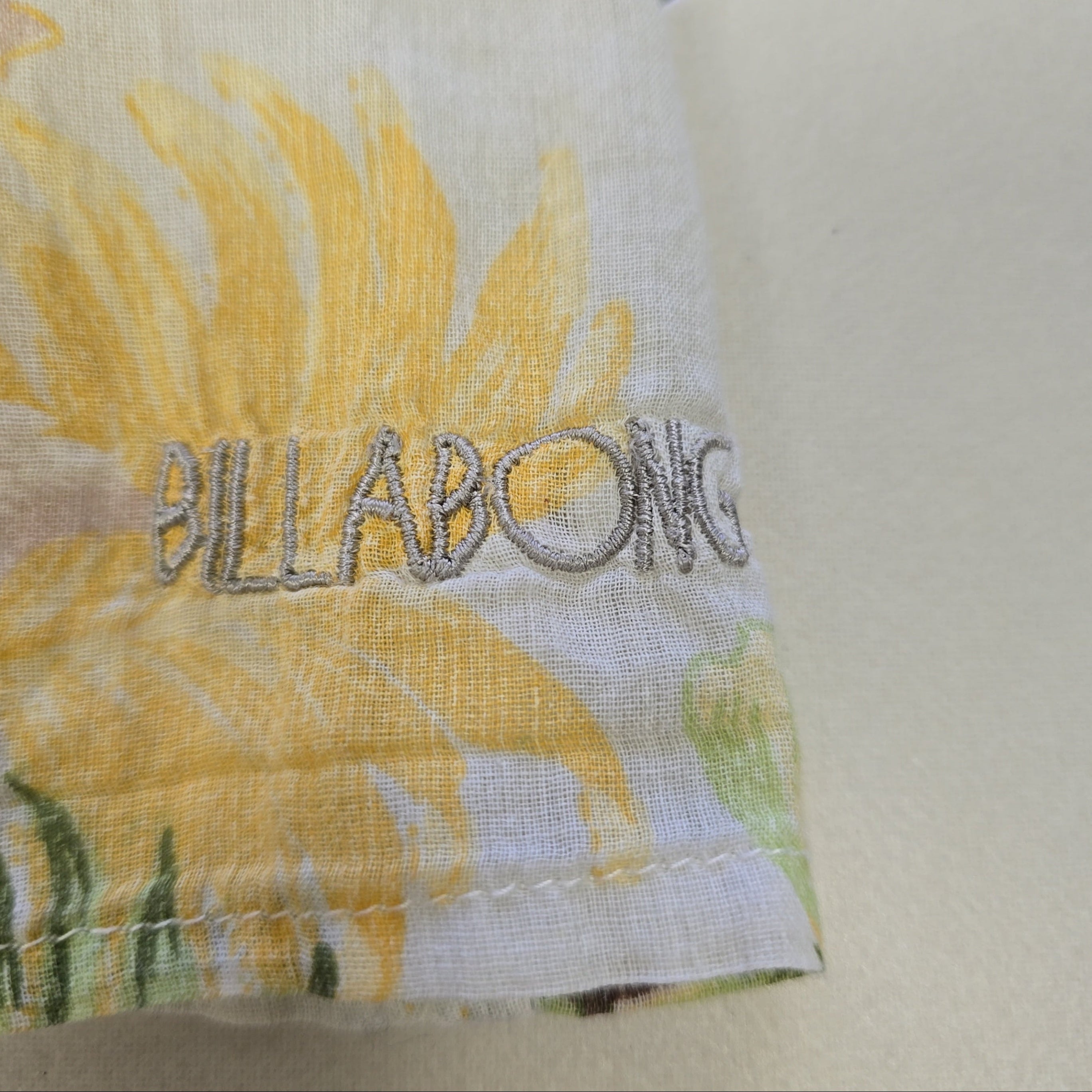 Fabric with sunflower pattern and 'Biltmore' branding on a neutral background