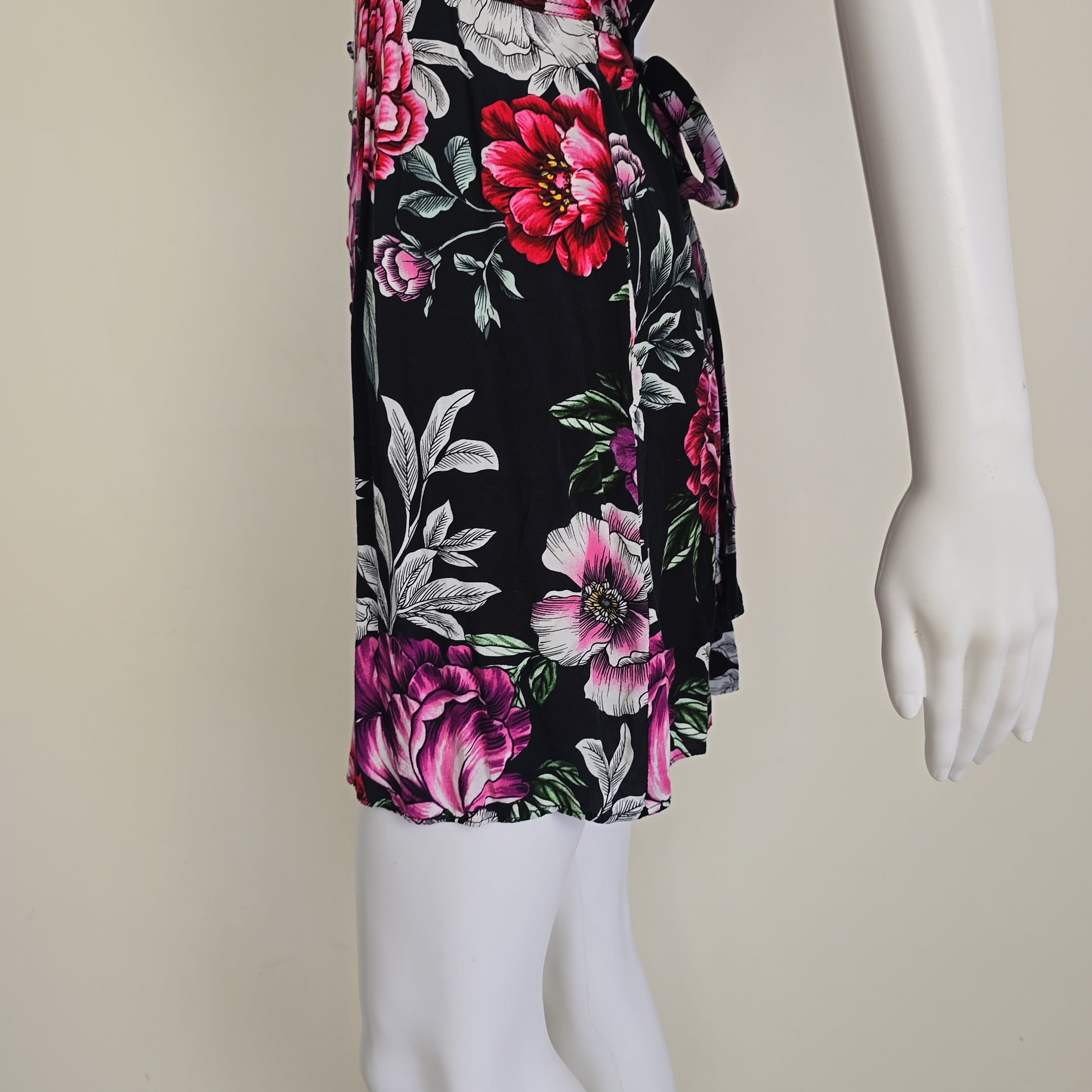 Floral-patterned dress on a mannequin against a neutral background