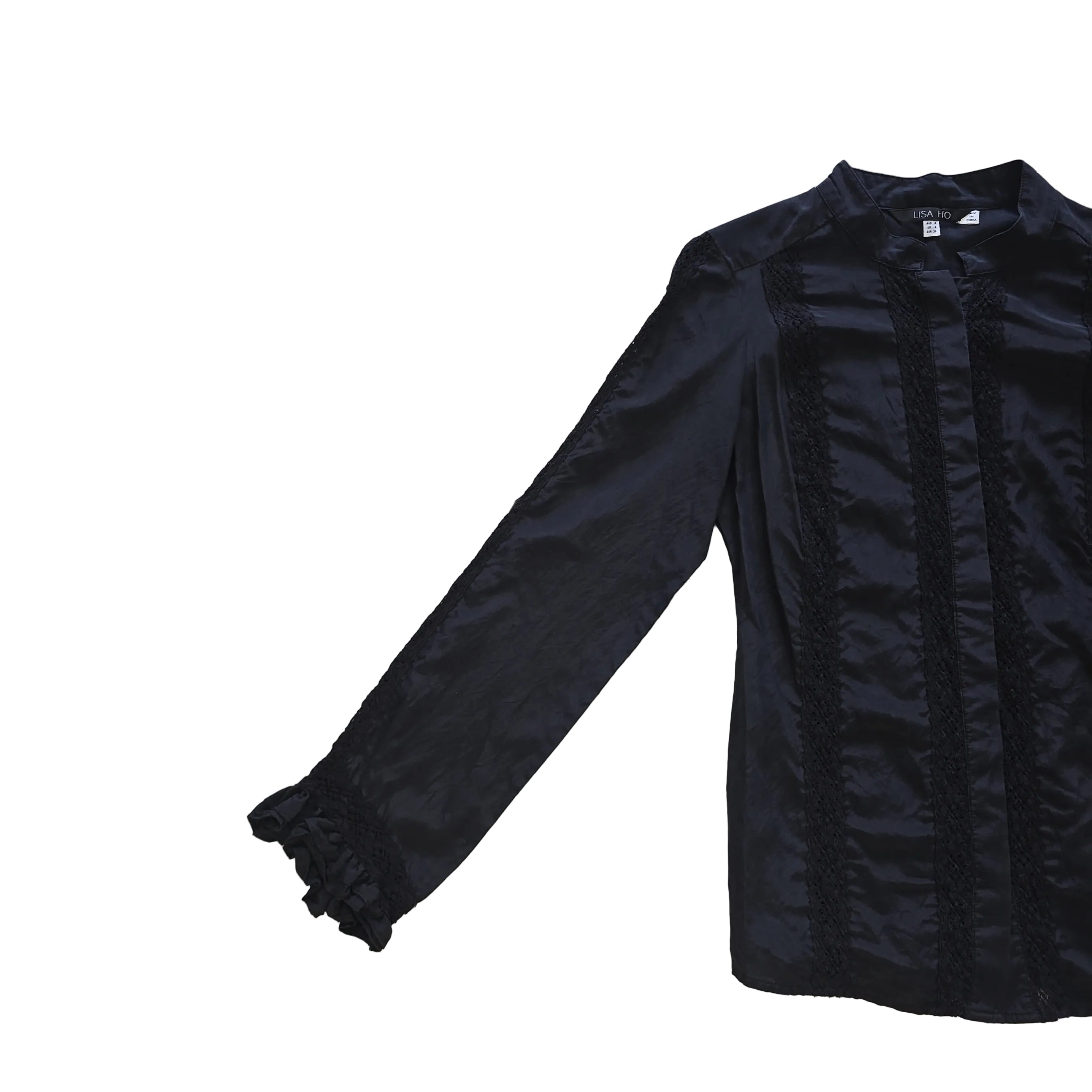 Black long sleeved button up top with black lace details on a light background