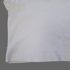 White fabric with subtle pattern on a beige surface