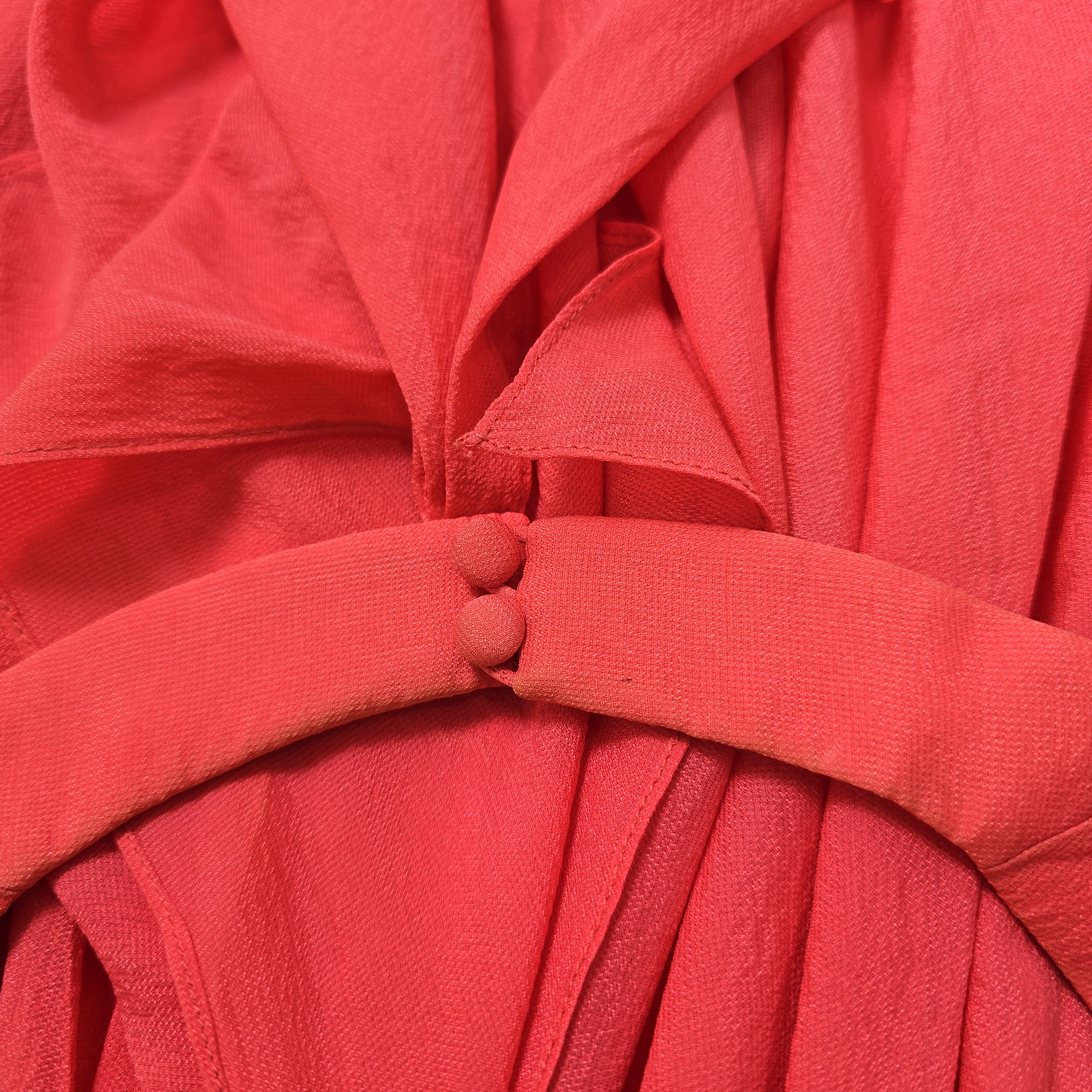 Close-up of a red fabric with pleated texture