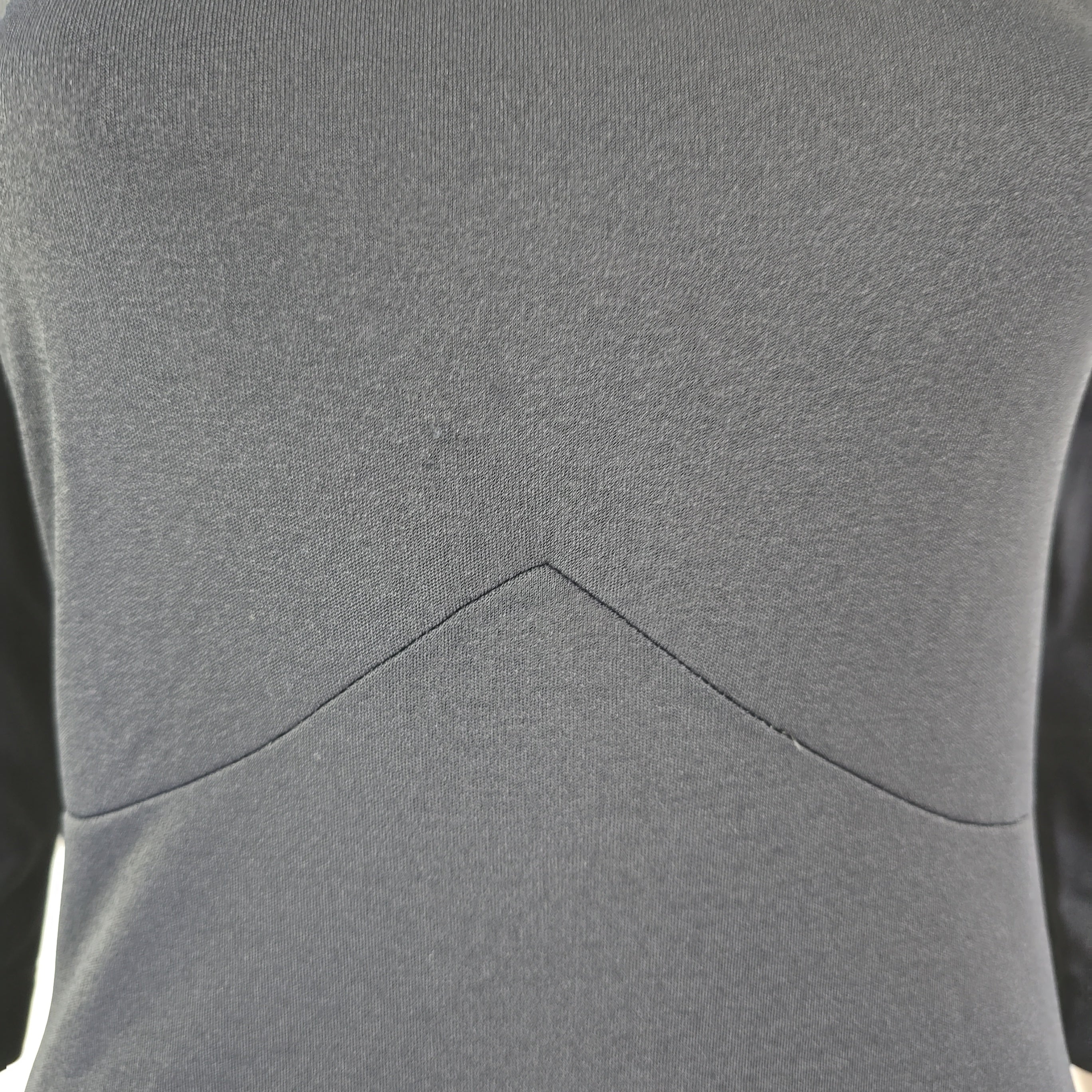 Close-up of the black dress with a visible seam.