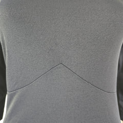 Close-up of the black dress with a visible seam.