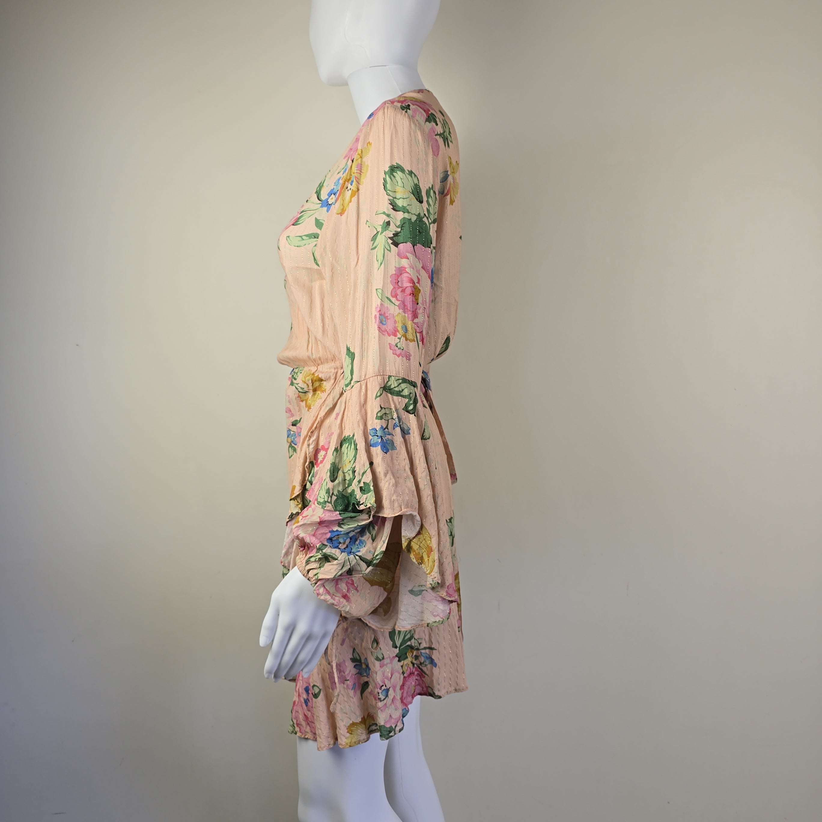 Floral dress on a mannequin against a plain background