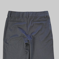 Dark gray pants on a tiled floor