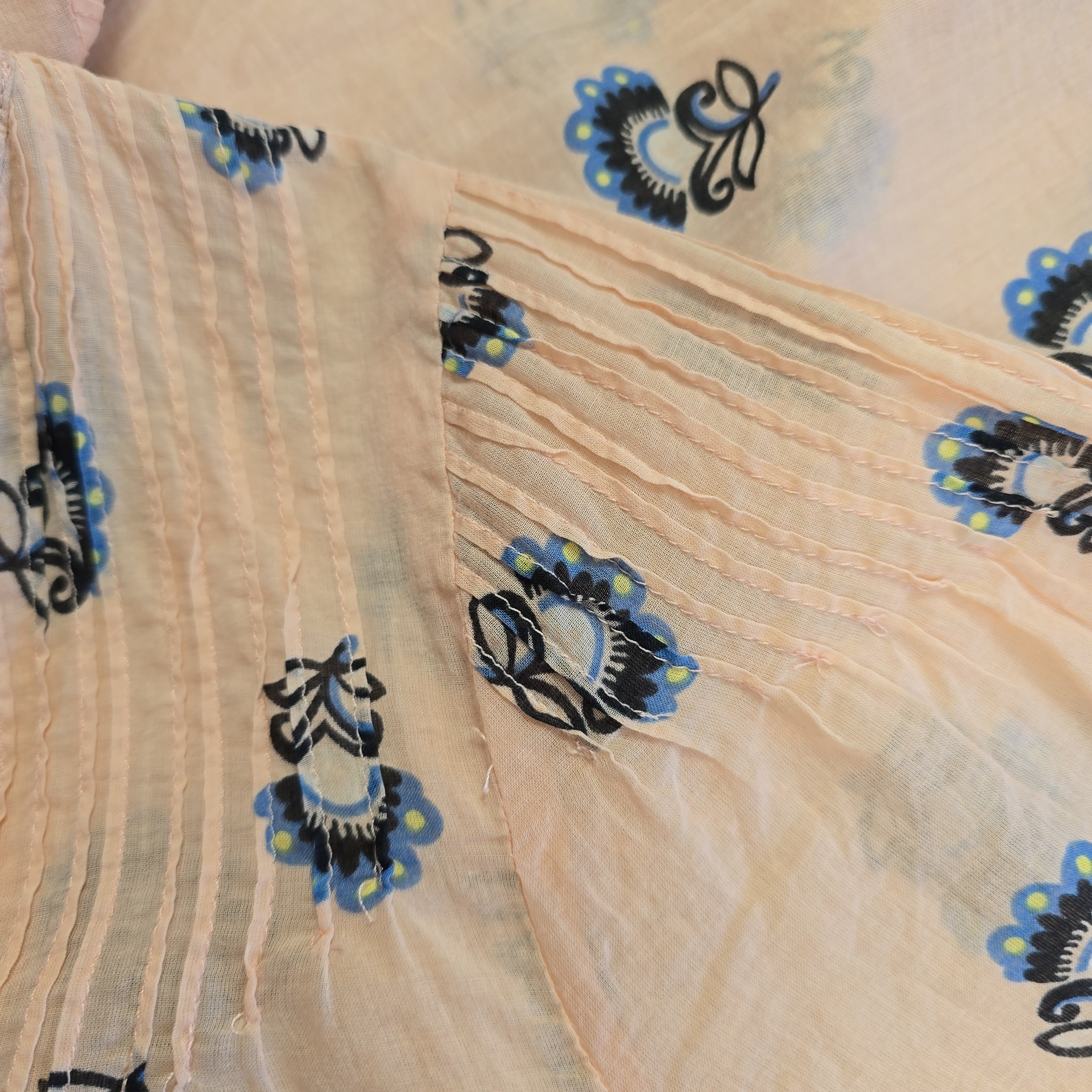 Beige fabric with blue and black floral patterns