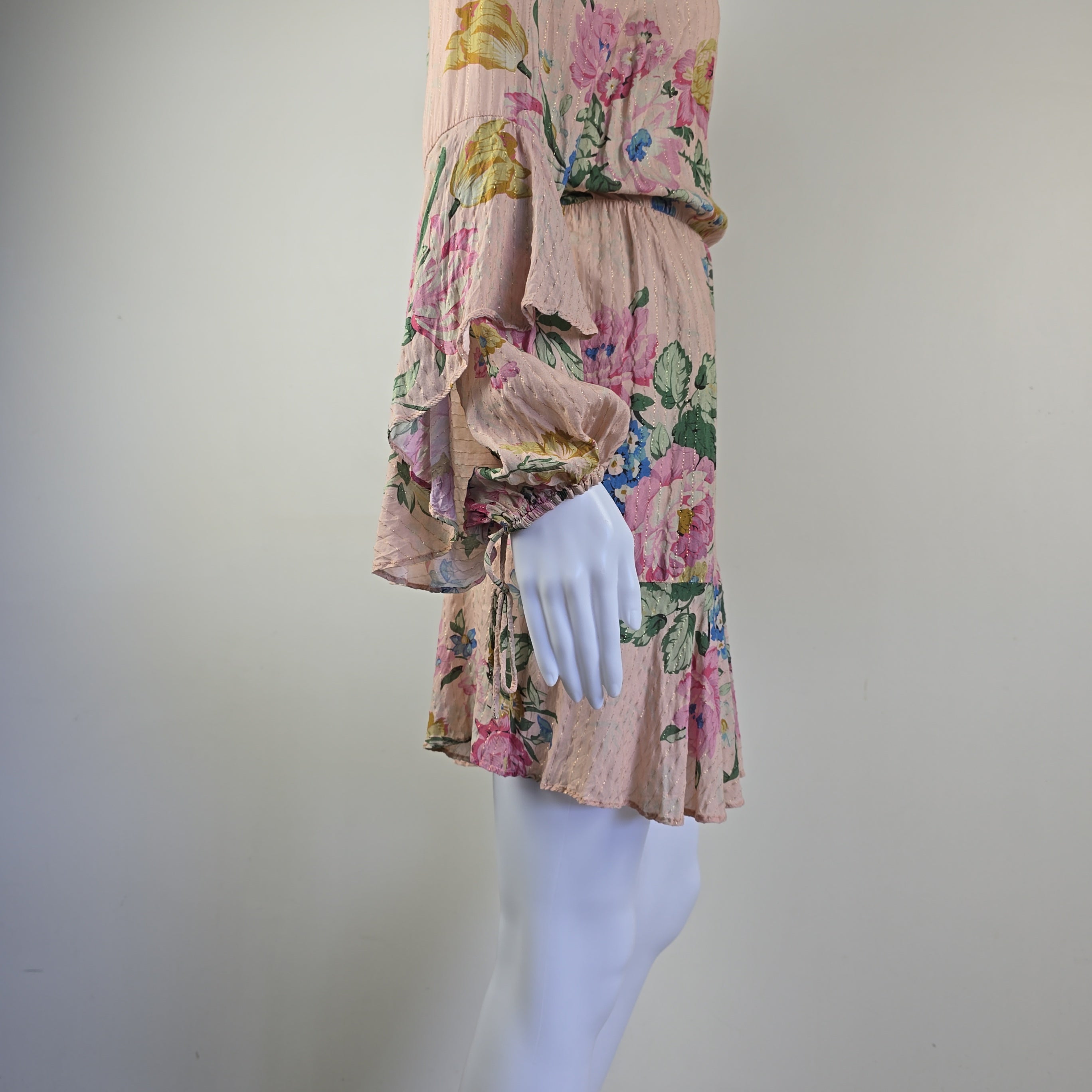 Floral-patterned fabric on a mannequin arm with a plain background