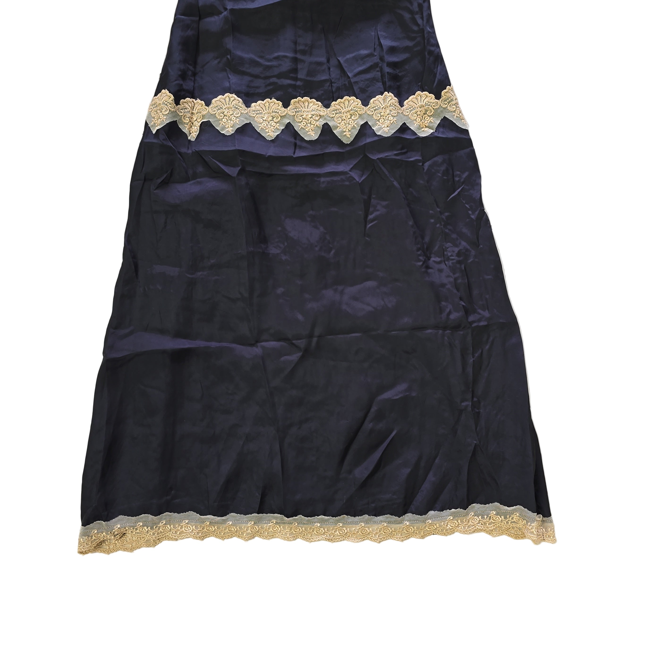 Black dress with beige lace details on a light background