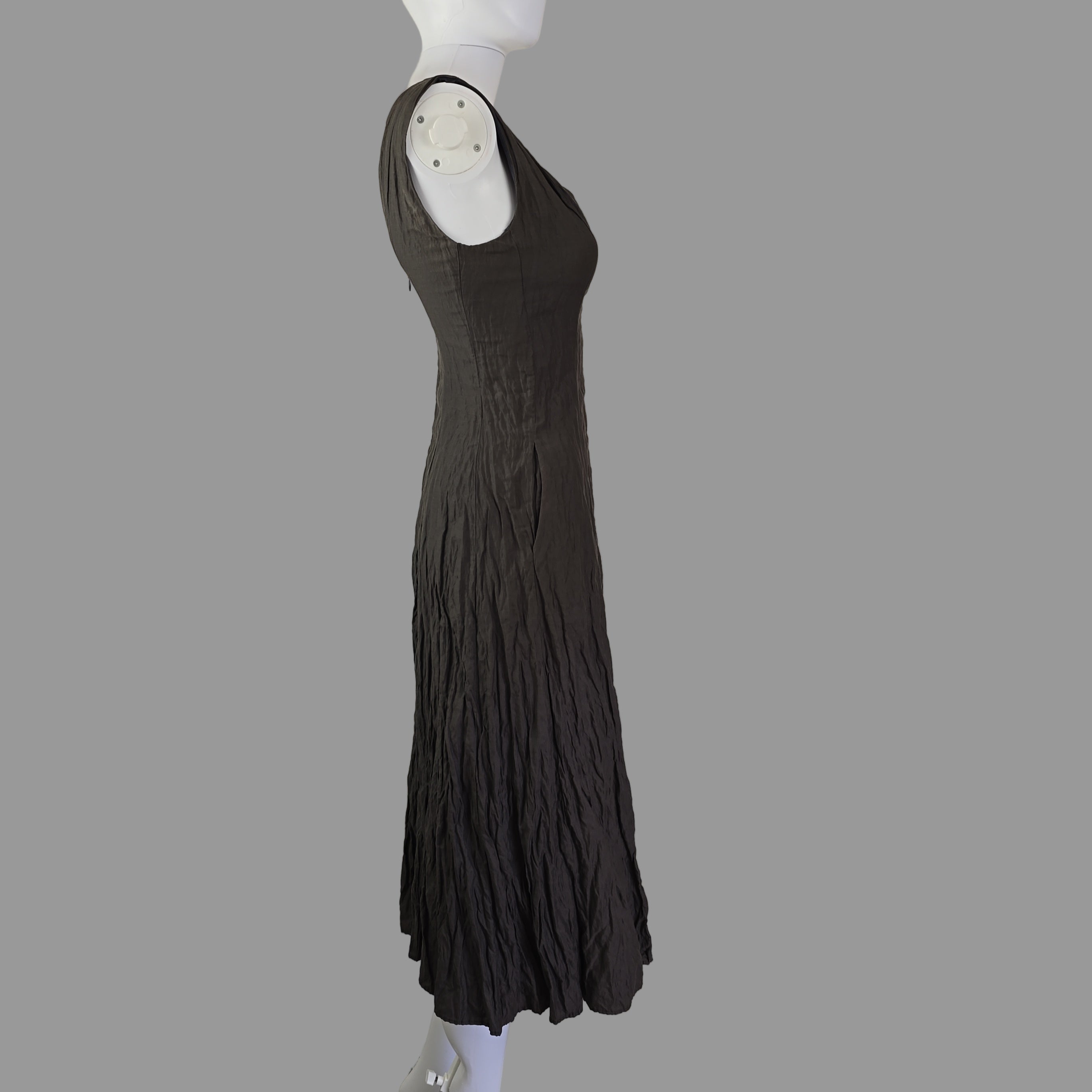 Black dress on a white surface with a neutral background