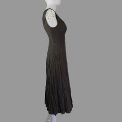 Black dress on a white surface with a neutral background