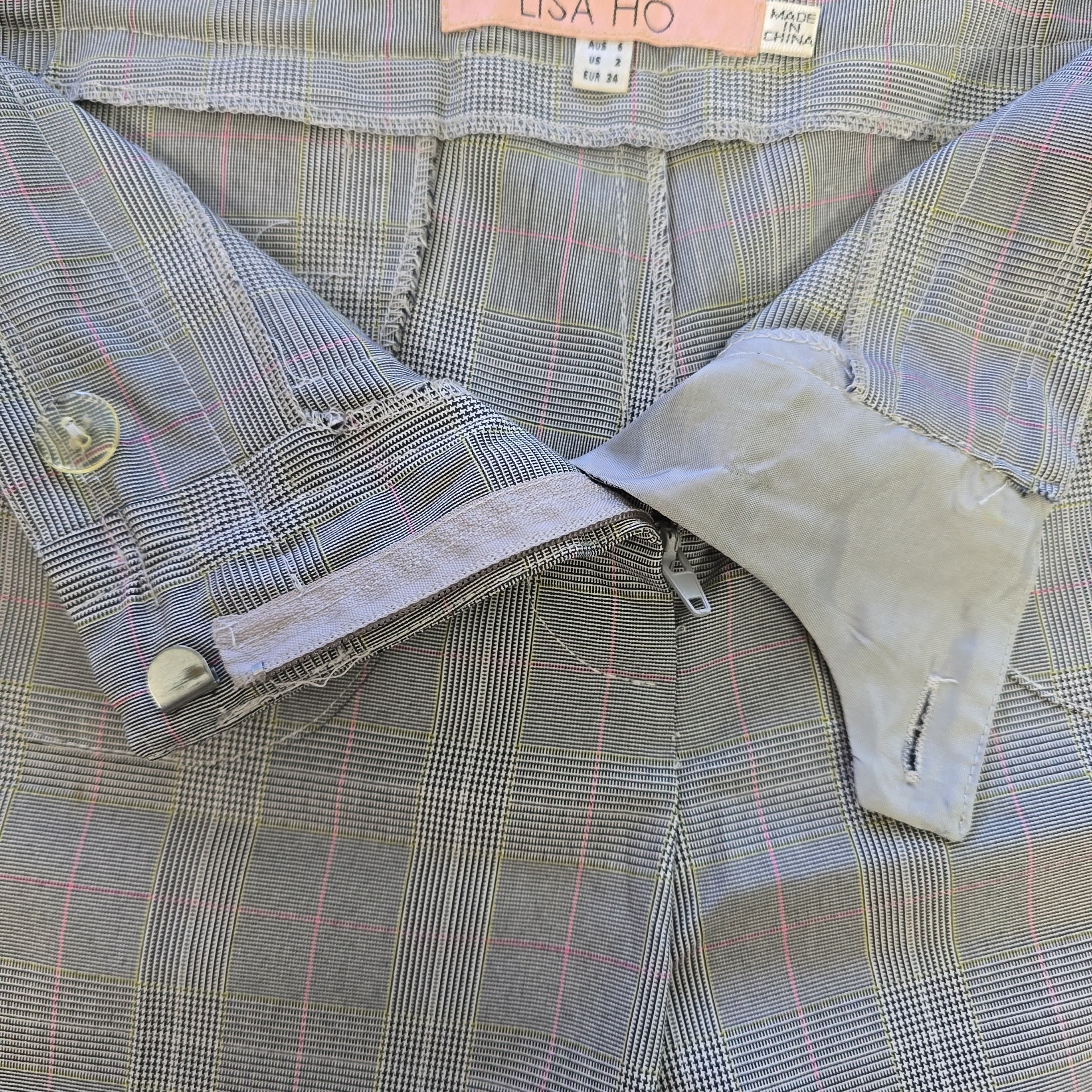Close-up of a plaid pants with a brand label visible