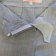 Close-up of a plaid pants with a brand label visible