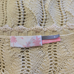 Close-up of a textured fabric with a patterned tag.