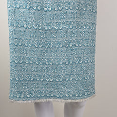 Textured blue fabric with white patterns on a light gray background