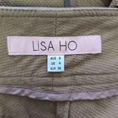 Close-up of a 'LISA HO' label on a garment with size information.