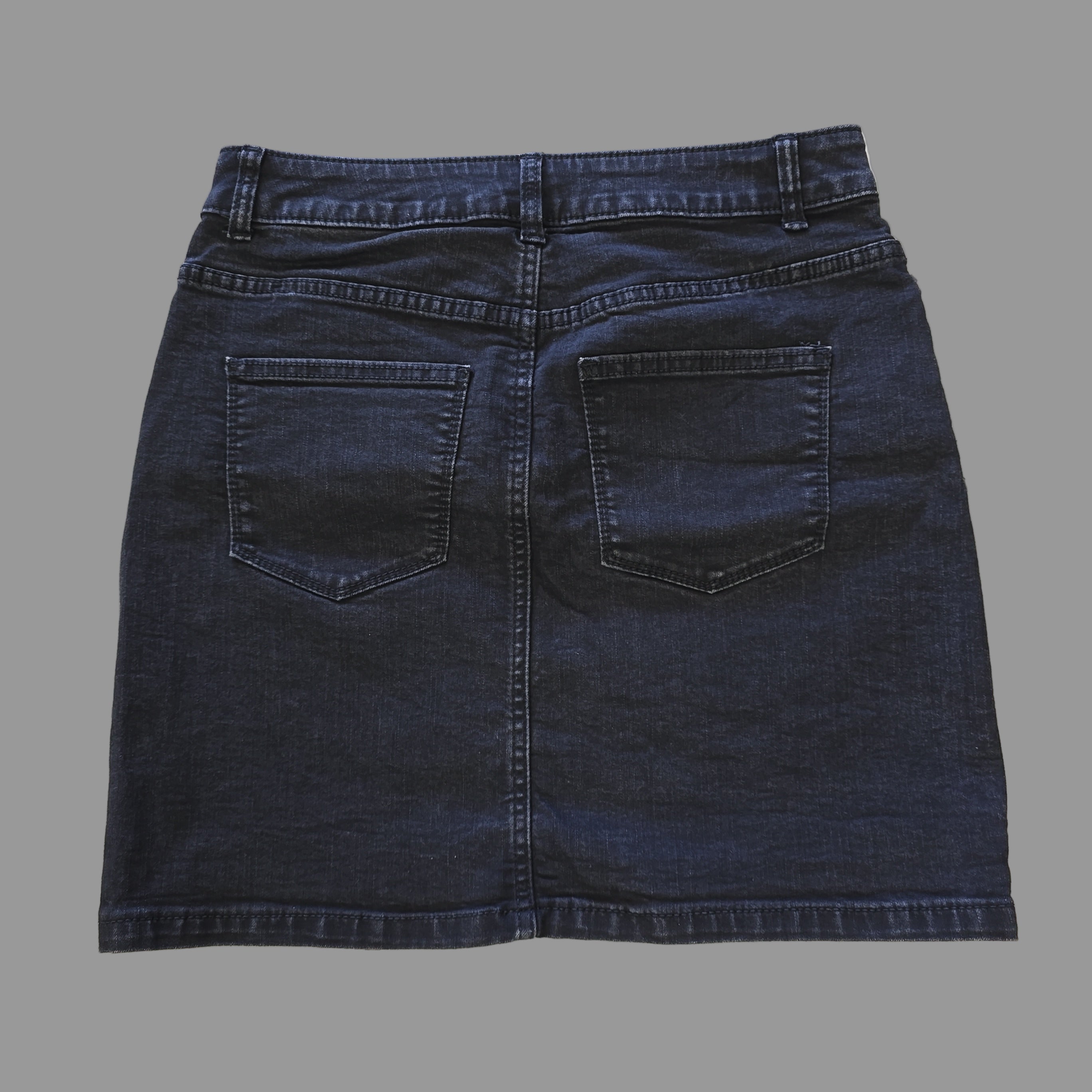 Grey denim skirt on a tiled floor