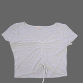 White sleeveless top on a tiled floor