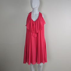 Red dress on a white mannequin against a plain background