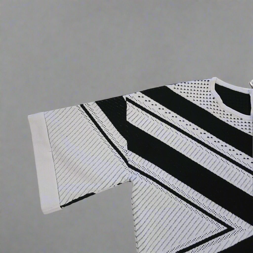 Black and white patterned sleeveless top on a tiled floor