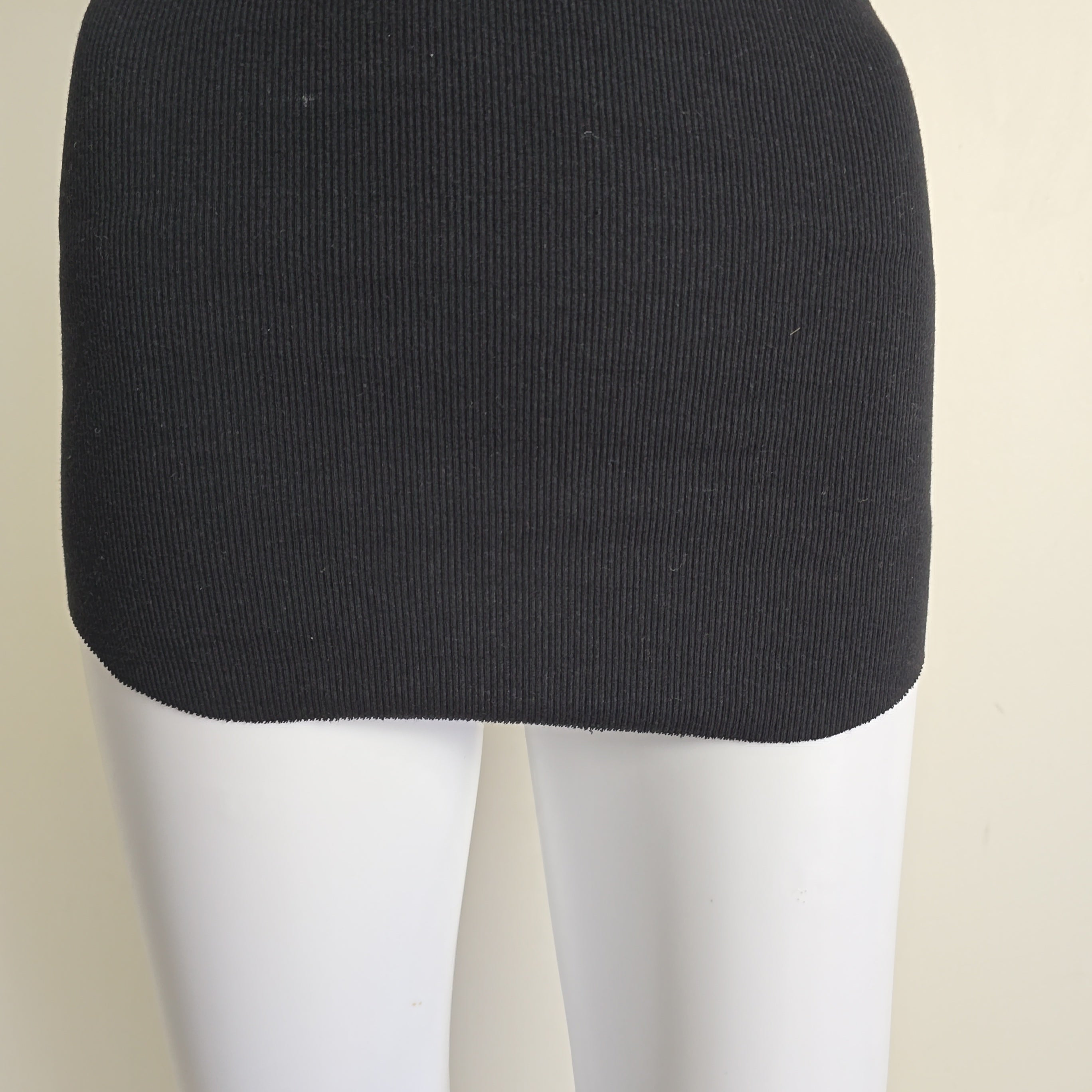 Black sleeveless top on a light background