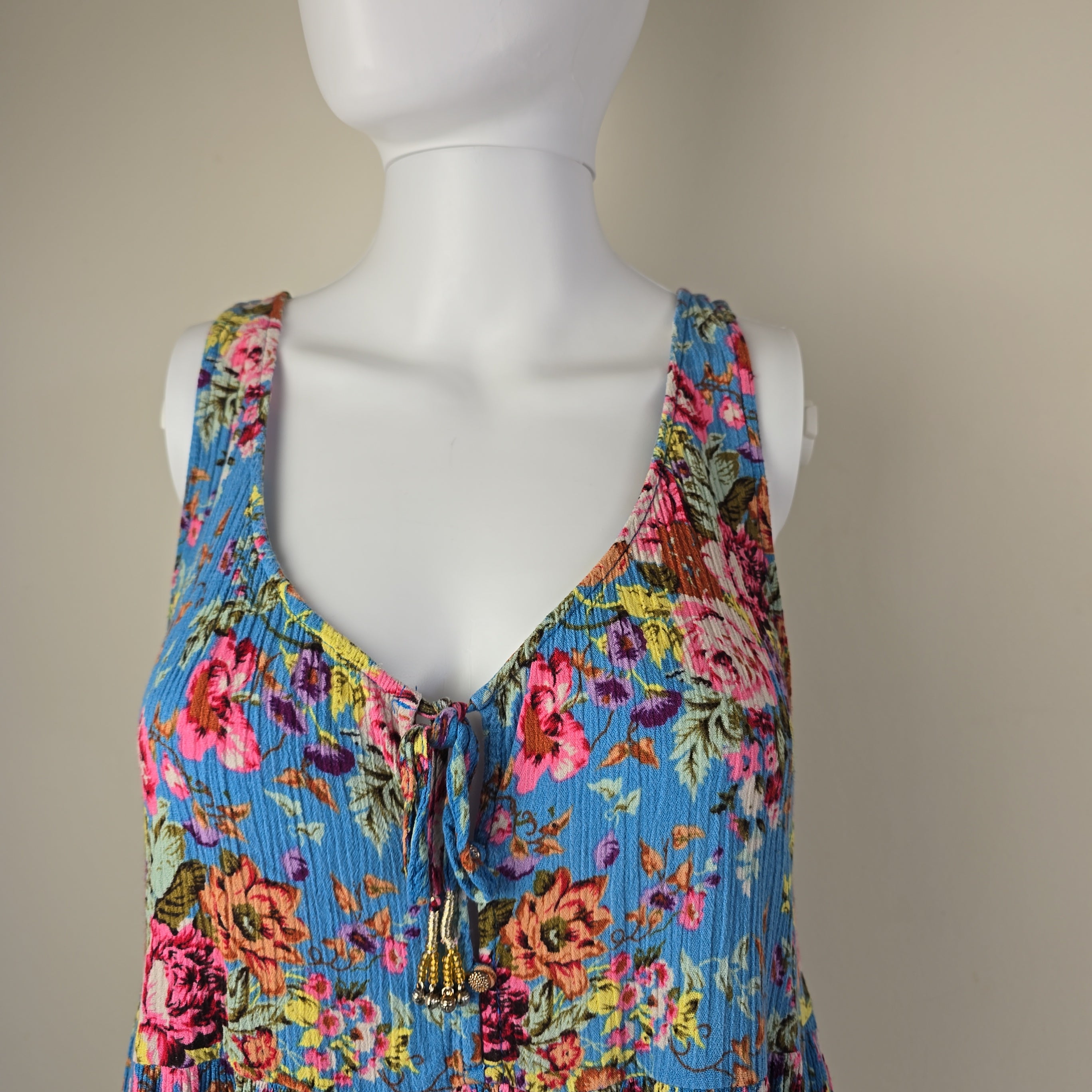 Mannequin wearing a colorful floral top with a light background