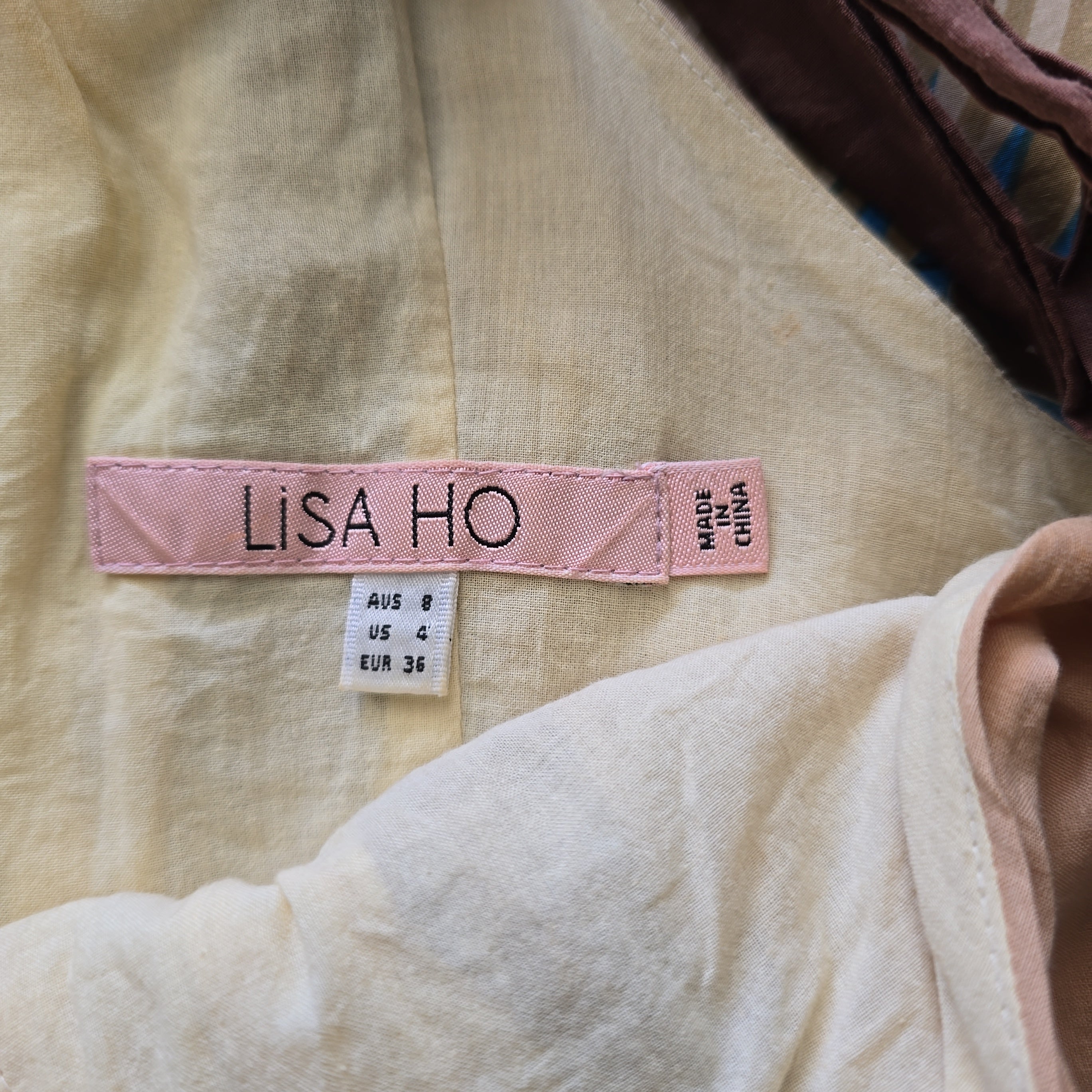 Pink label with 'LISA HO' on a fabric background