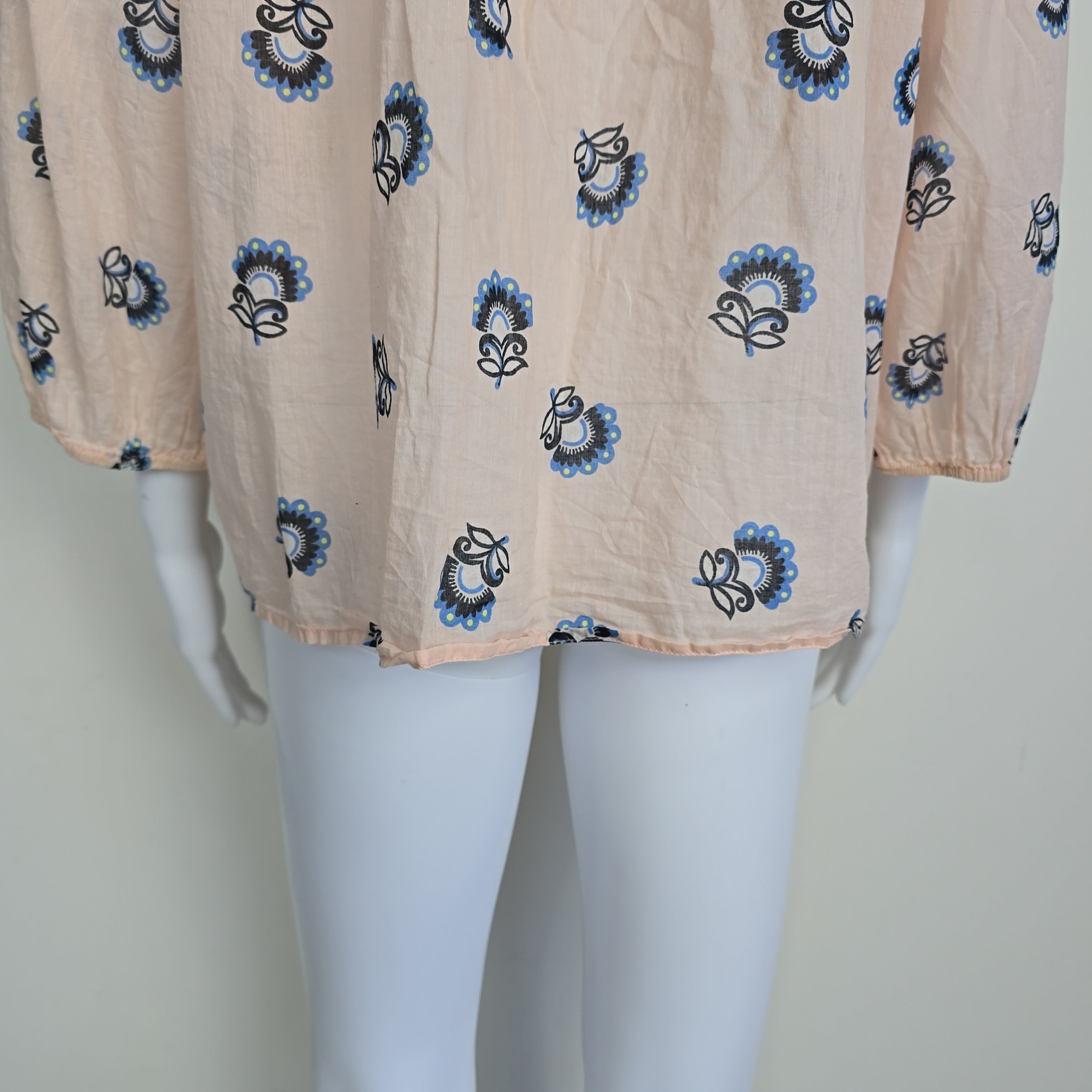 Beige fabric with blue and black floral patterns on a mannequin.