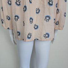 Beige fabric with blue and black floral patterns on a mannequin.