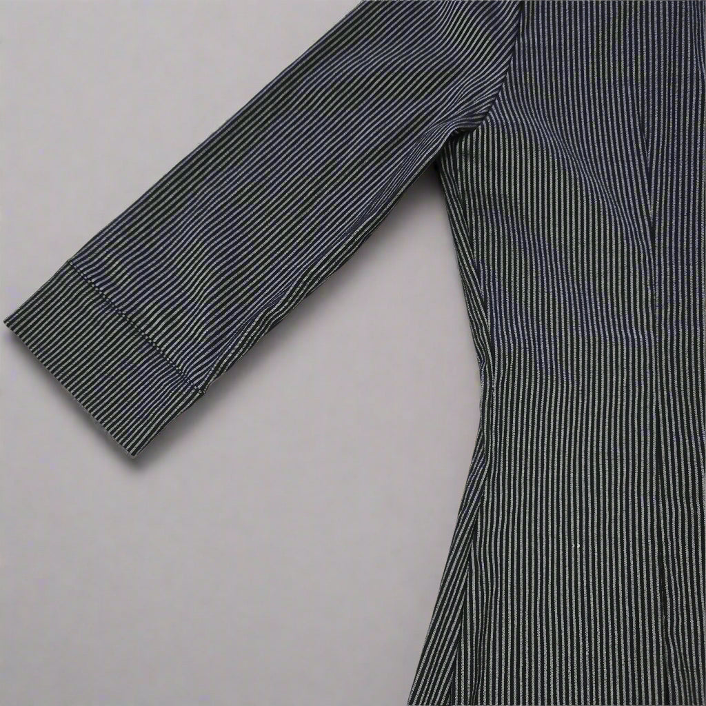 Dark blue striped shirt on a tiled floor