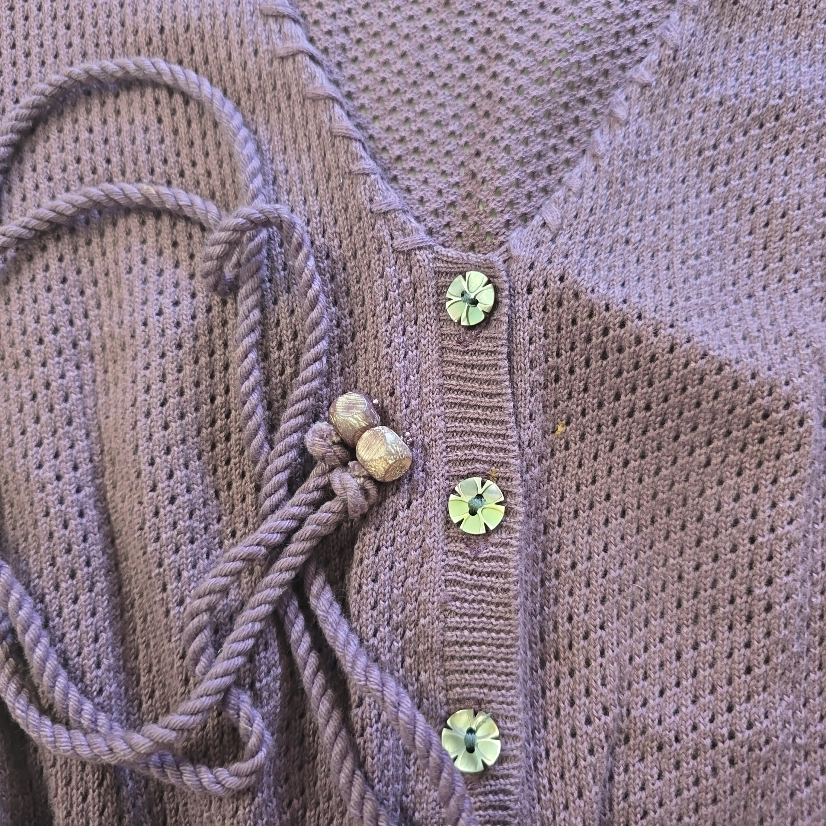 Close-up of a woventop with decorative elements on a textured background