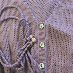 Close-up of a woventop with decorative elements on a textured background