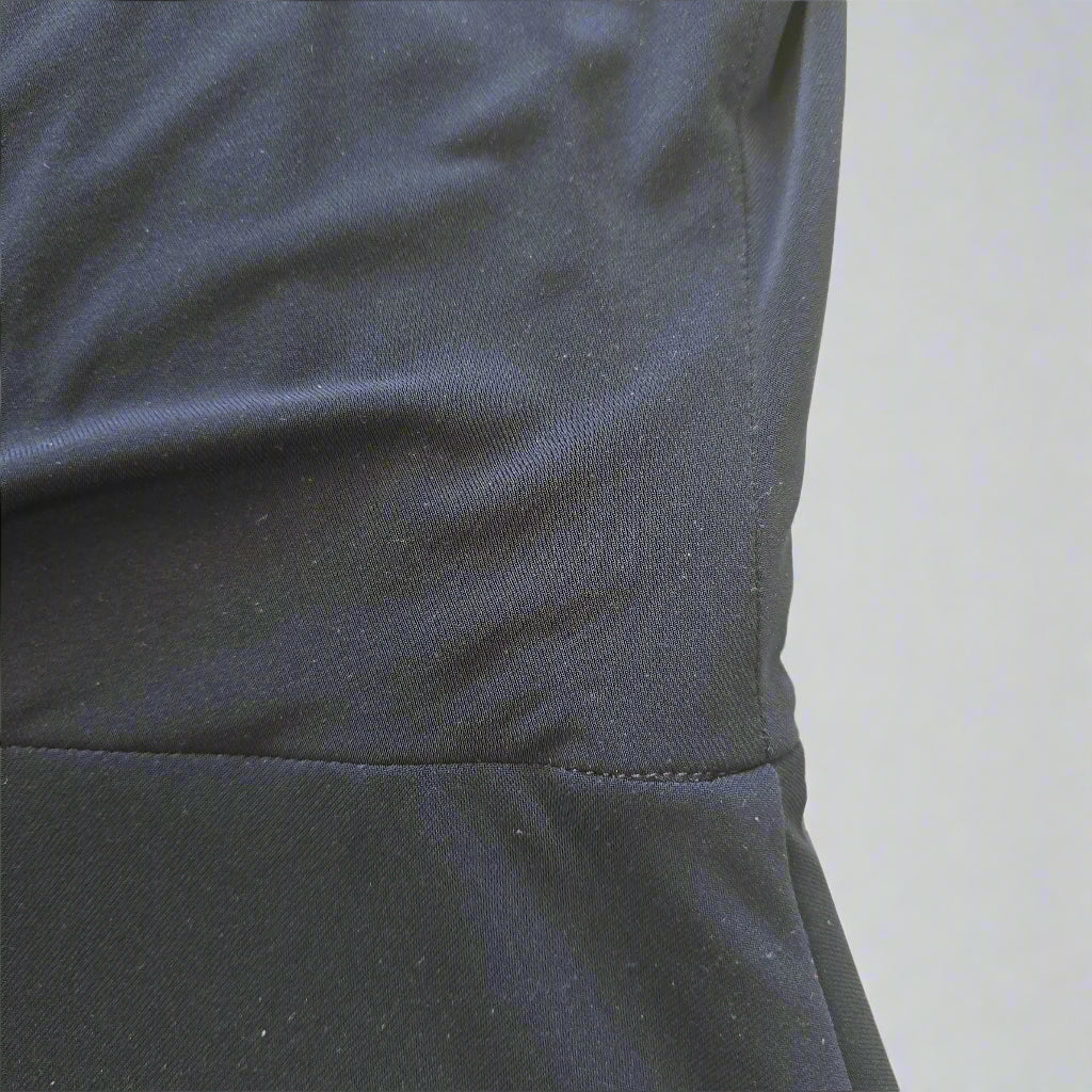 Close-up of a dark blue fabric with a yellow tiled background