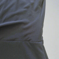 Close-up of a dark blue fabric with a yellow tiled background