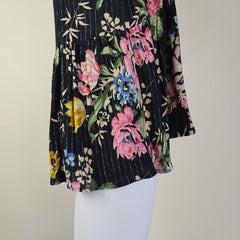 Floral fabric with pink, blue, and yellow flowers on a black background