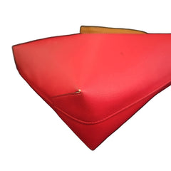 Red handbag with a visible brand logo on a light background