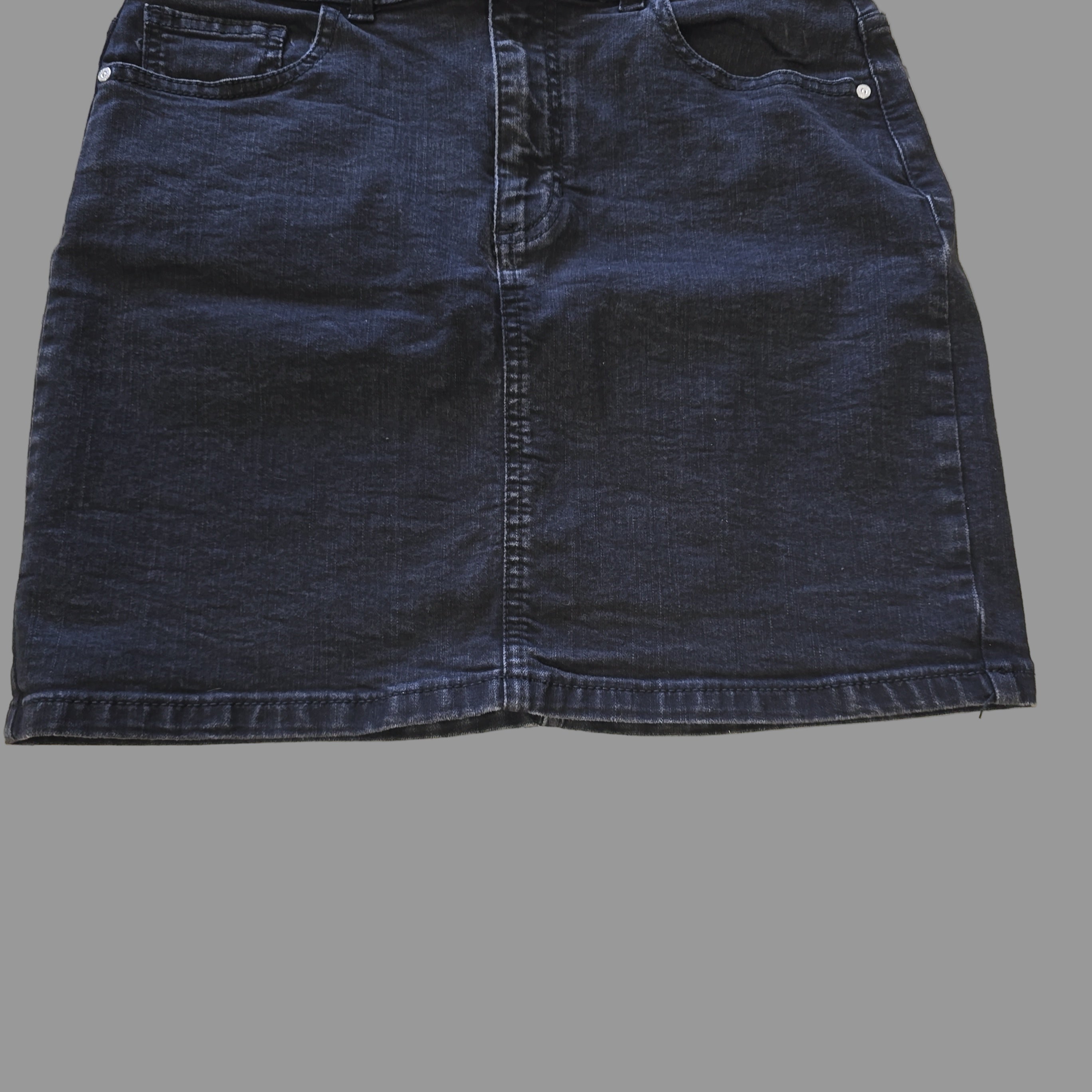 Grey denim skirt on a tiled floor