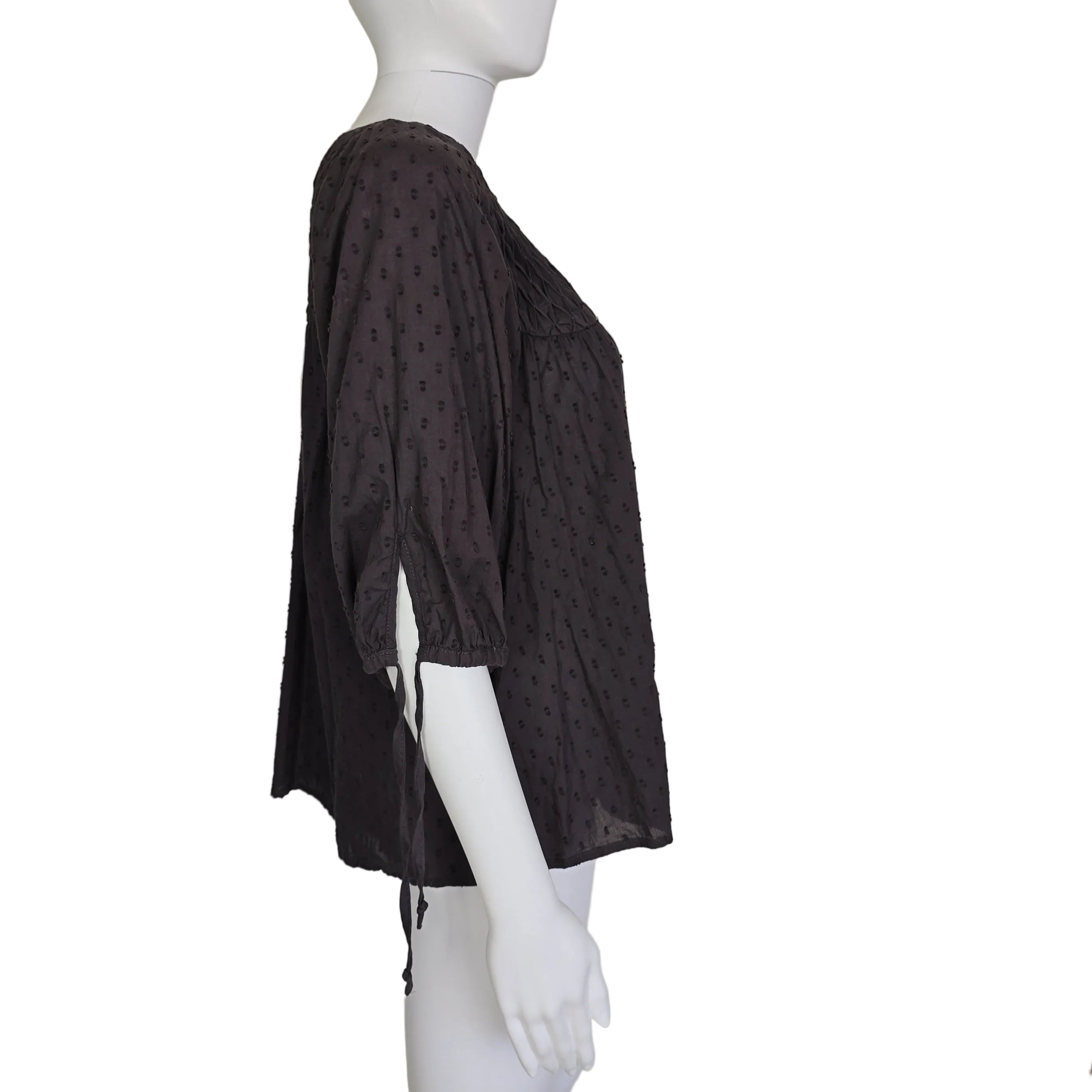 Brown patterned top on a mannequin against a plain background