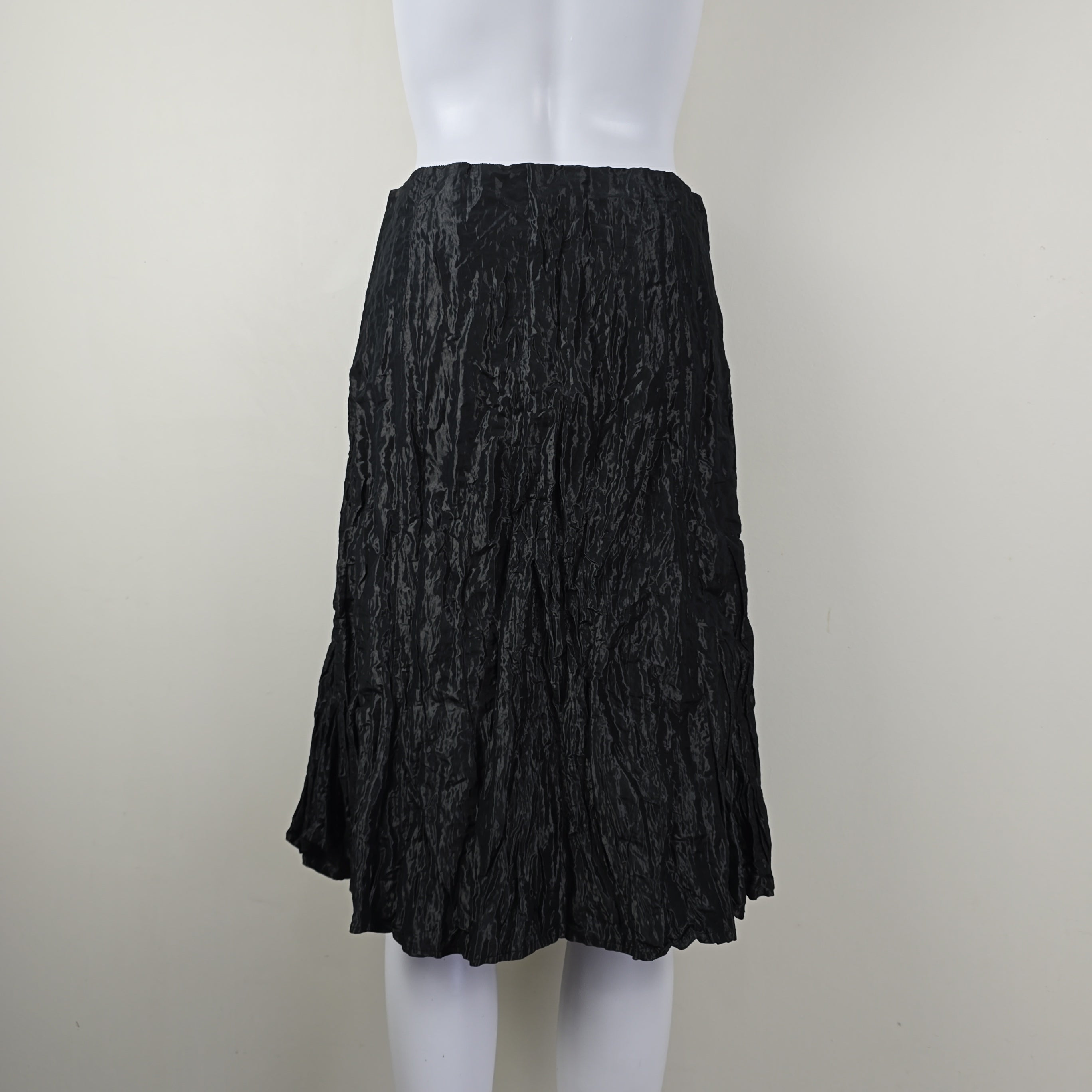Black crumpled skirt on a white background
