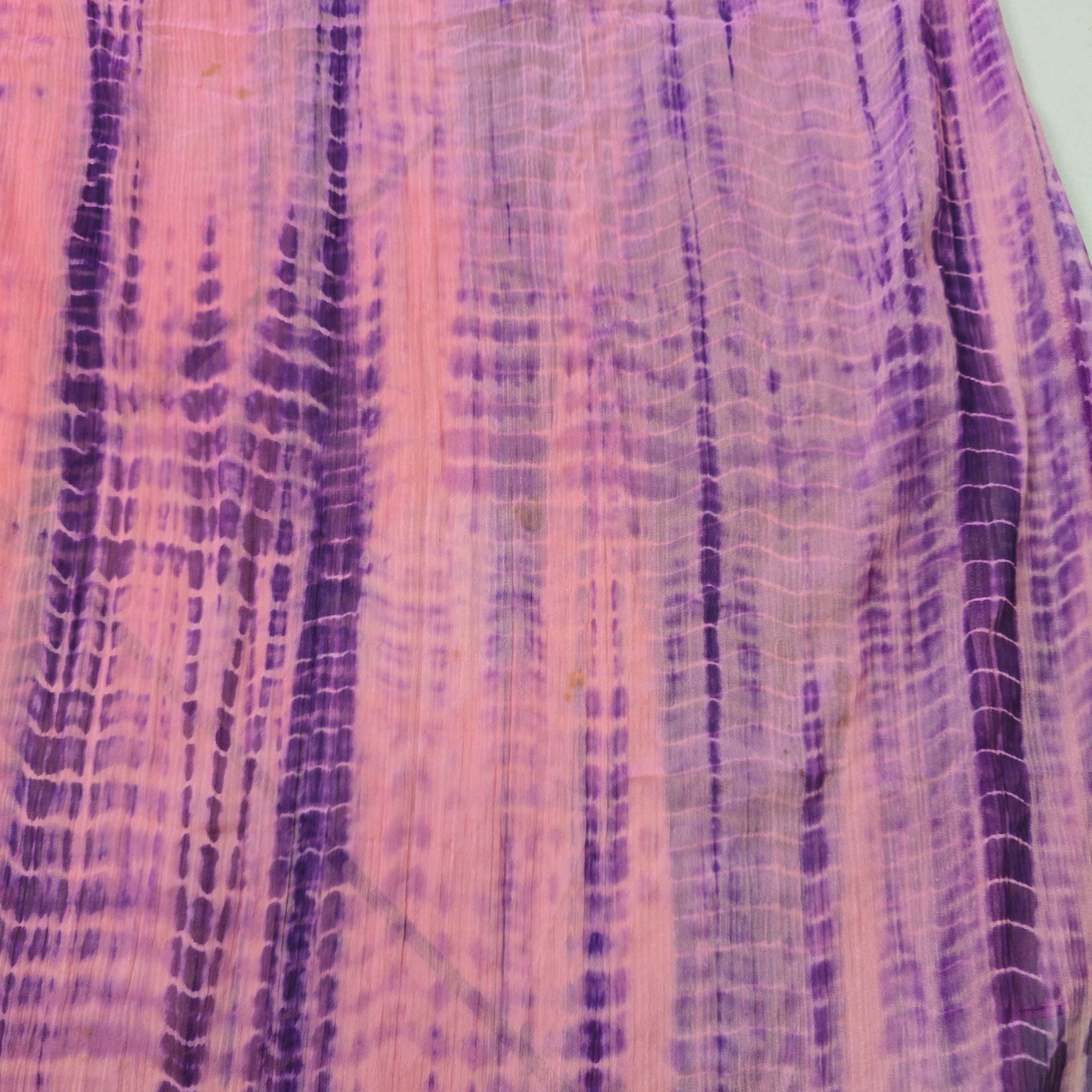 Close-up of a textured fabric with purple and pink hues