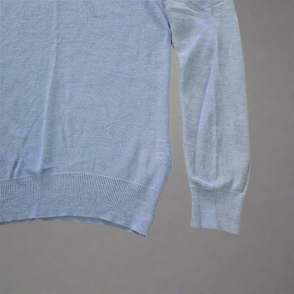 Folded blue fabric on a tiled floor